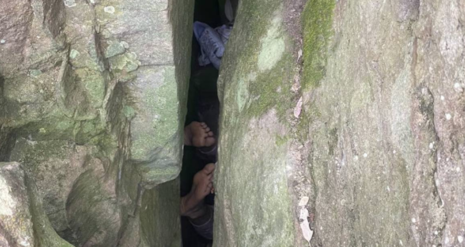 While trying to pick up the mobile phone that fell between the rocks the woman got stuck upside down in the gap Despite seven hours of effort he was out