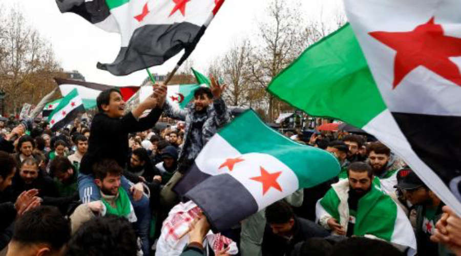 Syrian Rebels Attack Grave of Former President Hafez al-Assad Raise HTS Flag
