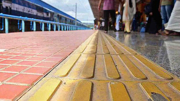 Some areas of railway platforms are tiled with yellow tiles