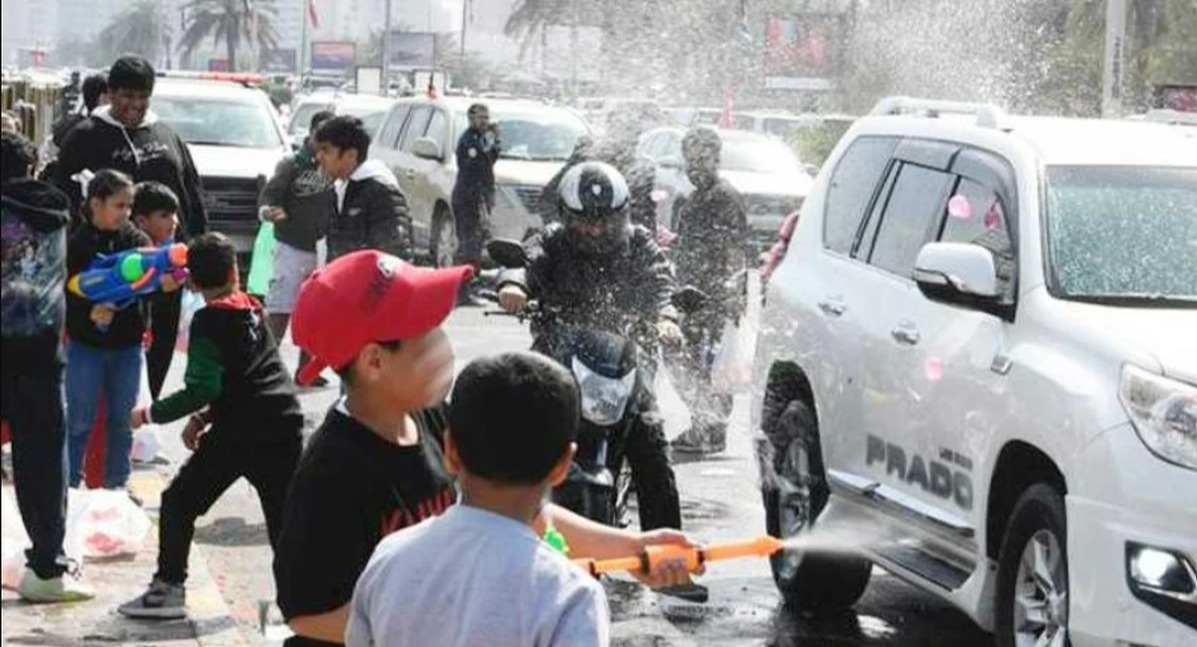 Children spray water during national day celebrations as Kuwait Municipality urges the public to avoid water guns and littering